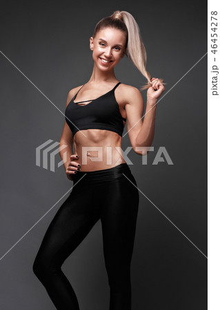Sports girl with pumped muscles,beauty body in a tracksuit, leading a healthy lifestyle and posing Sports girl with pumped muscles,beauty body in a tracksuit, leading a healthy lifestyle and posing 46454278