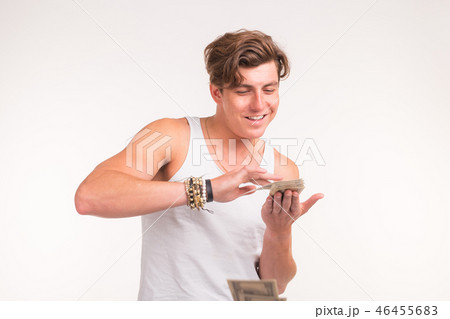 Concept of financial wealth, prosperity and lottery winnings - Man throwing away his money on white Concept of financial wealth, prosperity and lottery winnings - Man throwing away his money on white 46455683