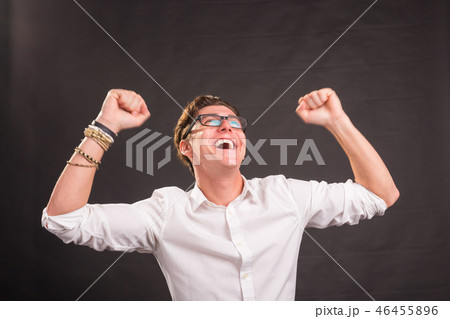Emotions, gesture and people concept - Handsome happy man in white shirt over grey background 46455896