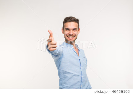 Portrait of stylish handsome young man with thumbs up isolated on white background 46456103