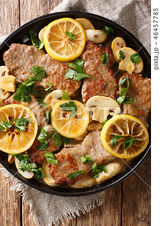 Italian veal scaloppini with mushrooms and lemons Italian veal scaloppini with mushrooms and lemons 46457785