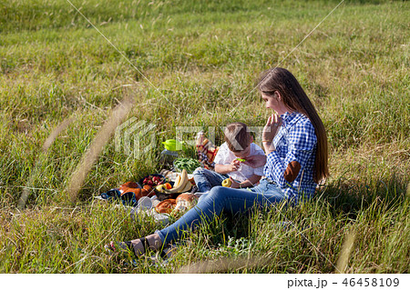 mother and young son eating at a picnic outdoors tent 46458109