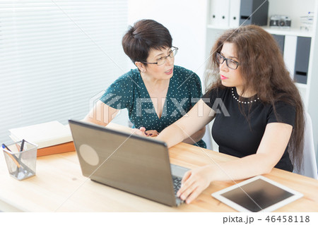 Office, business people and graphic designer concept - Women sitting and discussing ideas at the Office, business people and graphic designer concept - Women sitting and discussing ideas at the 46458118