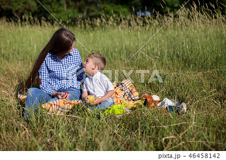 mother and young son eating at a picnic outdoors tent mother and young son eating at a picnic outdoors tent 46458142