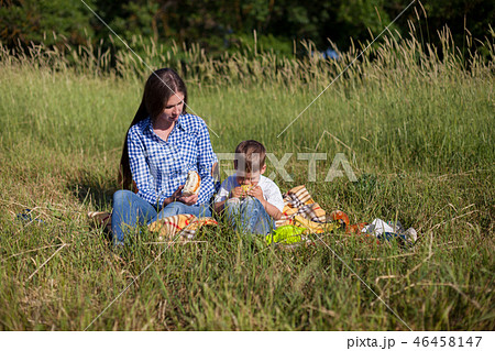 mother and young son eating at a picnic outdoors tent mother and young son eating at a picnic outdoors tent 46458147