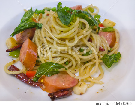 Spaghetti with the smoked sausage and basil sauce. 46458766