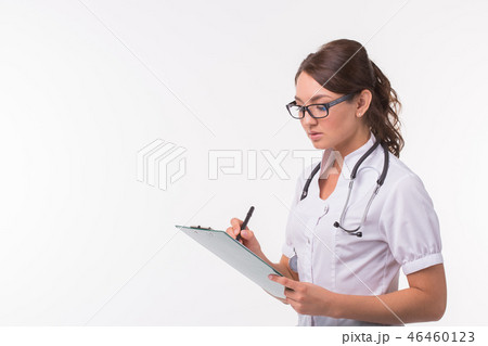 Female medicine doctor hand holding pen writing something on clipboard on white background with copy Female medicine doctor hand holding pen writing something on clipboard on white background with copy 46460123