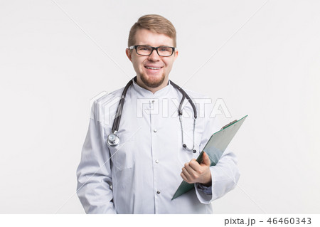 Medicine, health and treatment concept - Happy smiling doctor writing on clipboard, isolated on 46460343