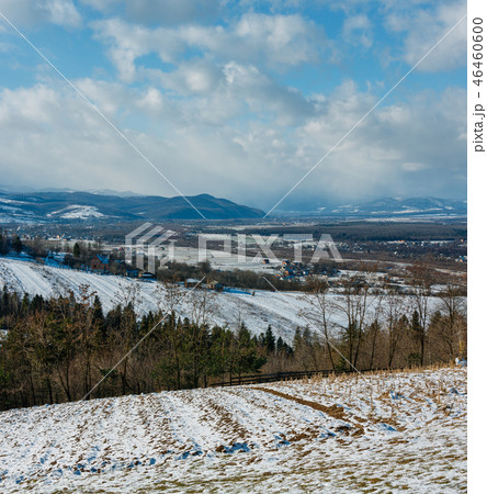 Winter mountain landscape with field and village 46460600