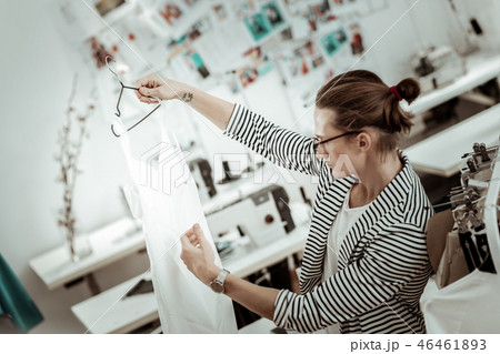Young handsome fashion dressmaker in eyeglasses working in a showroom 46461893