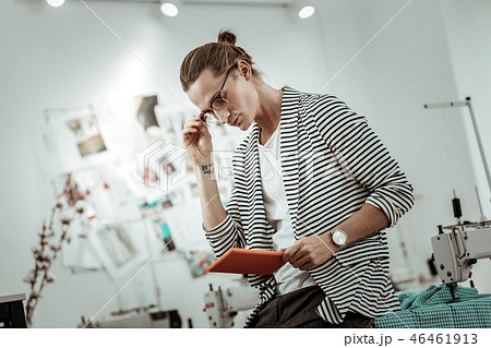 Fair-haired handsome fashion designer looking interested in his work 46461913