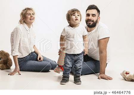 happy family with kid sitting together and smiling at camera isolated on white 46464776