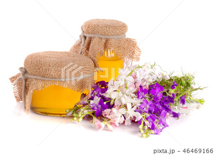Jar of honey with wildflowers isolated on white background Jar of honey with wildflowers isolated on white background 46469166