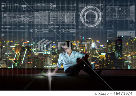 Asian businessman sitting and using the laptop showing digital virtual screen over the cityscape background at night time, Business technology and innovation concept Asian businessman sitting and using the laptop showing digital virtual screen over the cityscape background at night time, Business technology and innovation concept 46471974