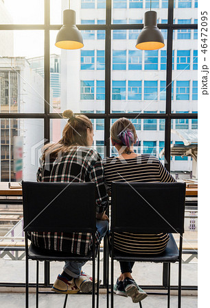 Backside of Hipster young couple freelancer using smart Laptop for working in the Loft cafe workplace. Creative Startup and entrepreneur business concept Backside of Hipster young couple freelancer using smart Laptop for working in the Loft cafe workplace. Creative Startup and entrepreneur business concept 46472095