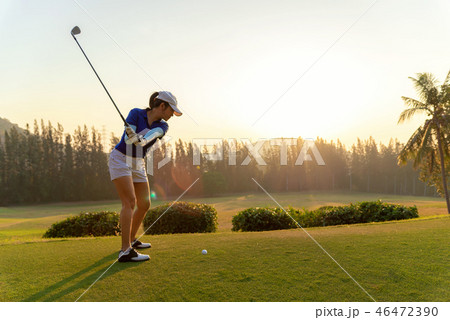 Asian woman golf player doing golf swing tee off 46472390