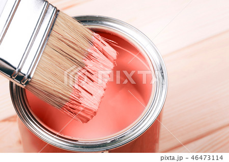 Brush with Living Coral paint on wooden background. 46473114