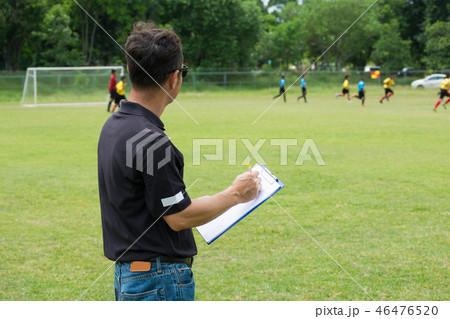 Team Manager Coaching Crew beside Football Field Team Manager Coaching Crew beside Football Field 46476520