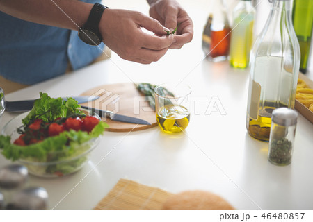 Man preparing herbs for delicious vegetable salad Man preparing herbs for delicious vegetable salad 46480857