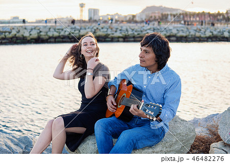 Coverband couple of musicians play acoustic guitar and sing near the beach 46482276