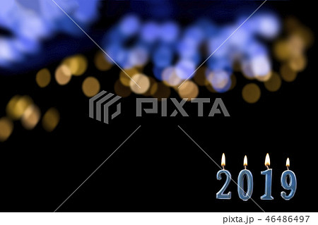 blue text of 2019 lit candle with flame blue text of 2019 lit candle with flame 46486497