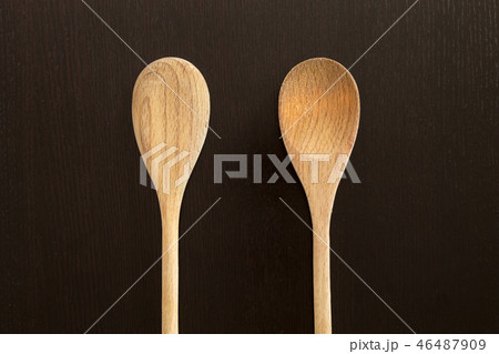 Wooden spoons on black table 46487909