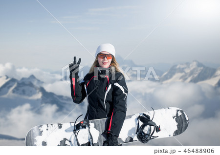 Young adult woman snowboarder holding snow board 46488906