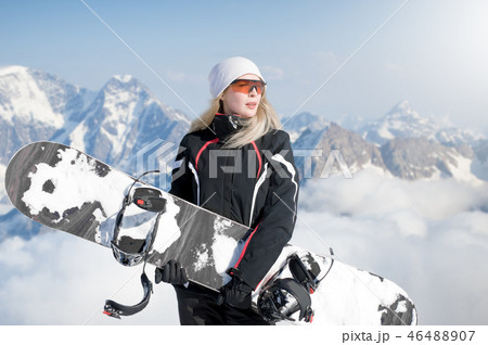 Young adult woman snowboarder holding snow board 46488907