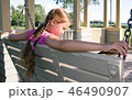 Dreamy girl sitting on swing bench in the park 46490907