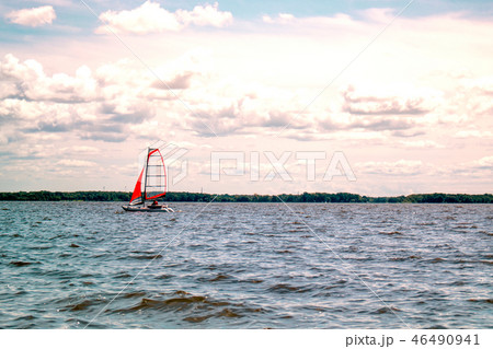 Boat sailing in the lake with a beautiful sky Boat sailing in the lake with a beautiful sky 46490941