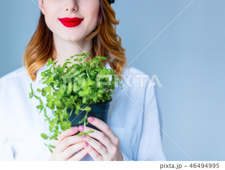Young redhead woman in hat holding herbs of oregano Young redhead woman in hat holding herbs of oregano 46494995