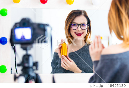 blogger woman applying cosmetics at camera  46495120