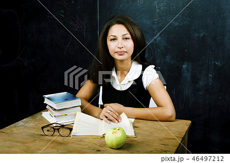 portrait of happy cute real teen student in classroom at blackbo 46497212