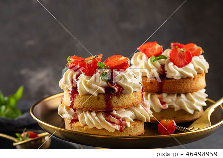 Victoria sponge cake with strawberries, jam and whipped cream on dark background. Copy space. 46498959