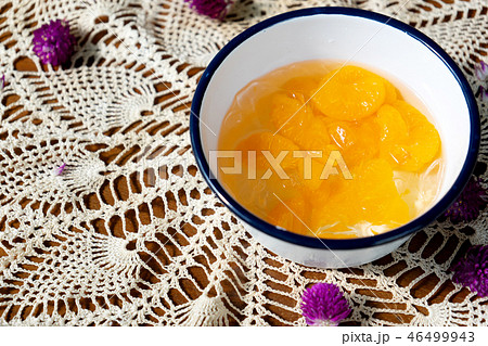 Orange with ice in Glass bowl on cloth Orange with ice in Glass bowl on cloth 46499943