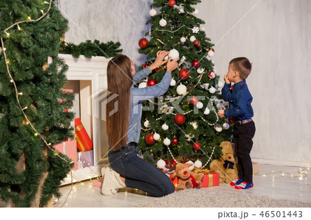 mom with son decorate Christmas tree new year gifts Garland lights mom with son decorate Christmas tree new year gifts Garland lights 46501443