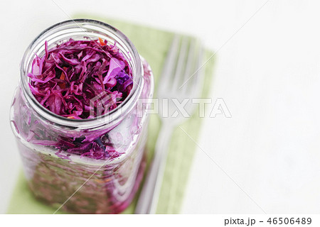 Jar with fermented cabbage and fork on napkin 46506489