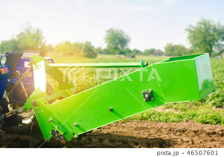 tractor in the field with a plow for digging 46507601