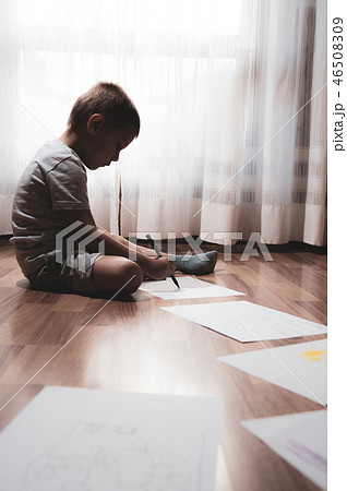child does his homework, writes and draws child does his homework, writes and draws 46508309