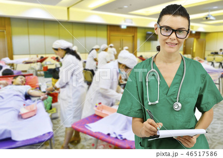 doctor with nurse receiving blood donation doctor with nurse receiving blood donation 46517586