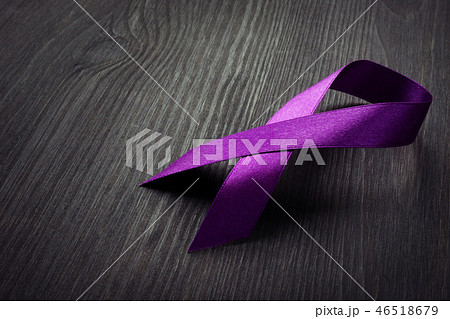 Purple awareness ribbon on desk Pancreatic cancer. 46518679