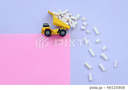 Dump truck throws marshmallow pieces Dump truck throws marshmallow pieces 46520908