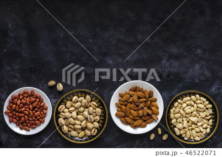 Border with bowls of assorted fresh nuts Border with bowls of assorted fresh nuts 46522071