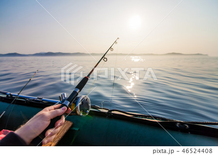 Fish-rod in fishermen's hand. Fish-rod in fishermen's hand. 46524408