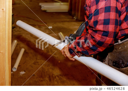 Worker in sawing PVC pipes,Industry Construction process to prepare cutting 46524628