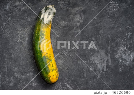Moldy zucchini on a black cement textured backgrou 46526690