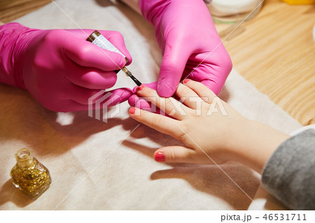 Little girl is getting manicure in beauty salon, close-up. 46531711
