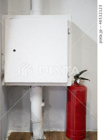 red fire extinguisher near white box with electric red fire extinguisher near white box with electric 46532123