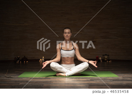Peaceful lady meditating while being alone with closed eyes Peaceful lady meditating while being alone with closed eyes 46535458
