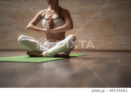 Close up of peaceful lady putting hands to the chest and meditating 46535661